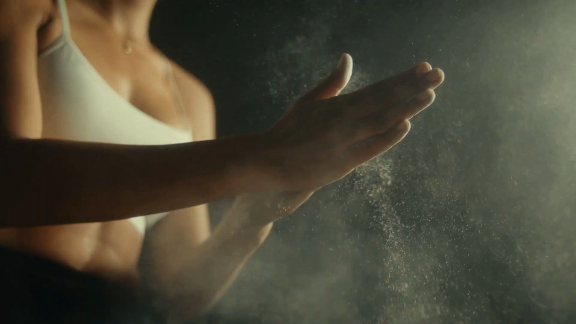Frame: chalked hands clapping, with dust in the air.